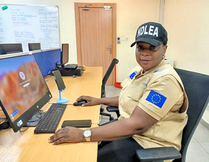 Helen Agboola Olajumoke working at her desk