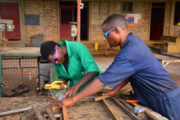 Young black men soldering iron