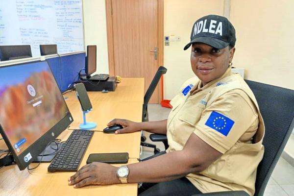 Helen Agboola Olajumoke working at her desk
